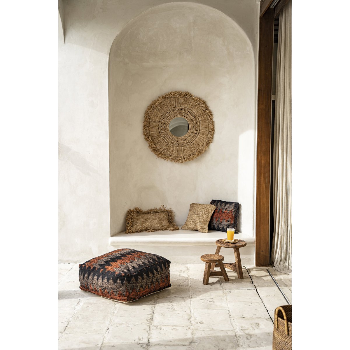 Bohemian zithoek met ronde spiegel en kleine houten kruk