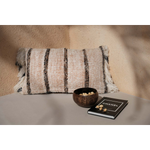 Ibiza Stripe kussenhoes in zachte boho sfeer, gestyled op tafel met kokosnootschaal en woonboek