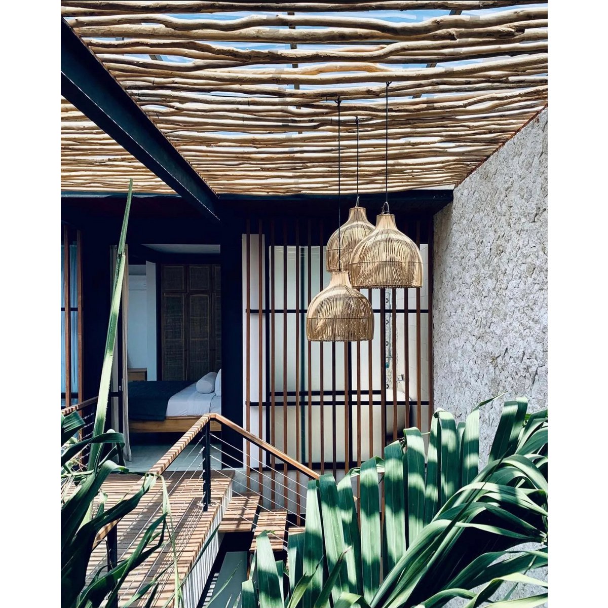 Solei Lume rotan hanglampen in tropisch interieur, met houten accenten en weelderige planten